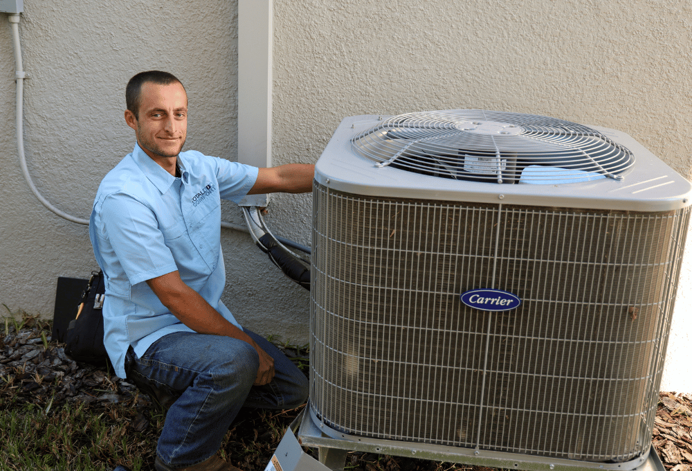 Total Comfort technician performing AC repair